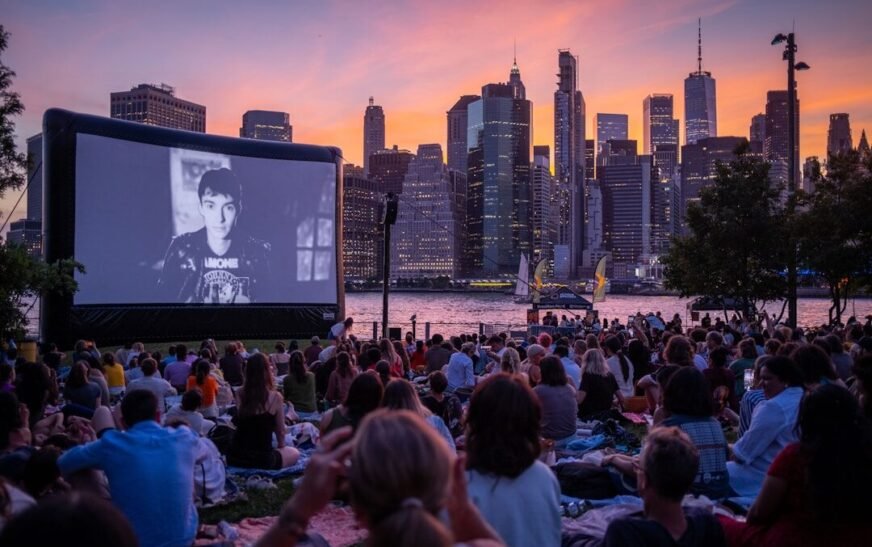 a large crowd of people watching a television screen