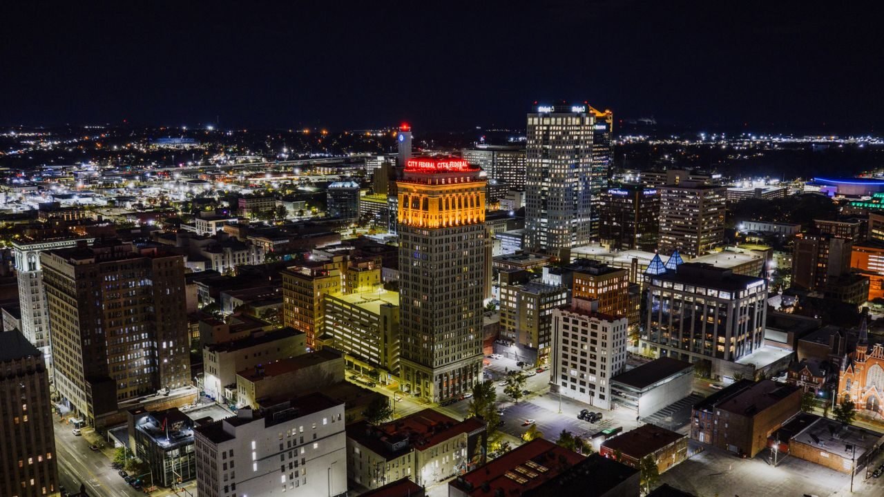 Stunning aerial view of Birmingham, Alabama at night showcasing the illuminated cityscape with prominent landmarks.