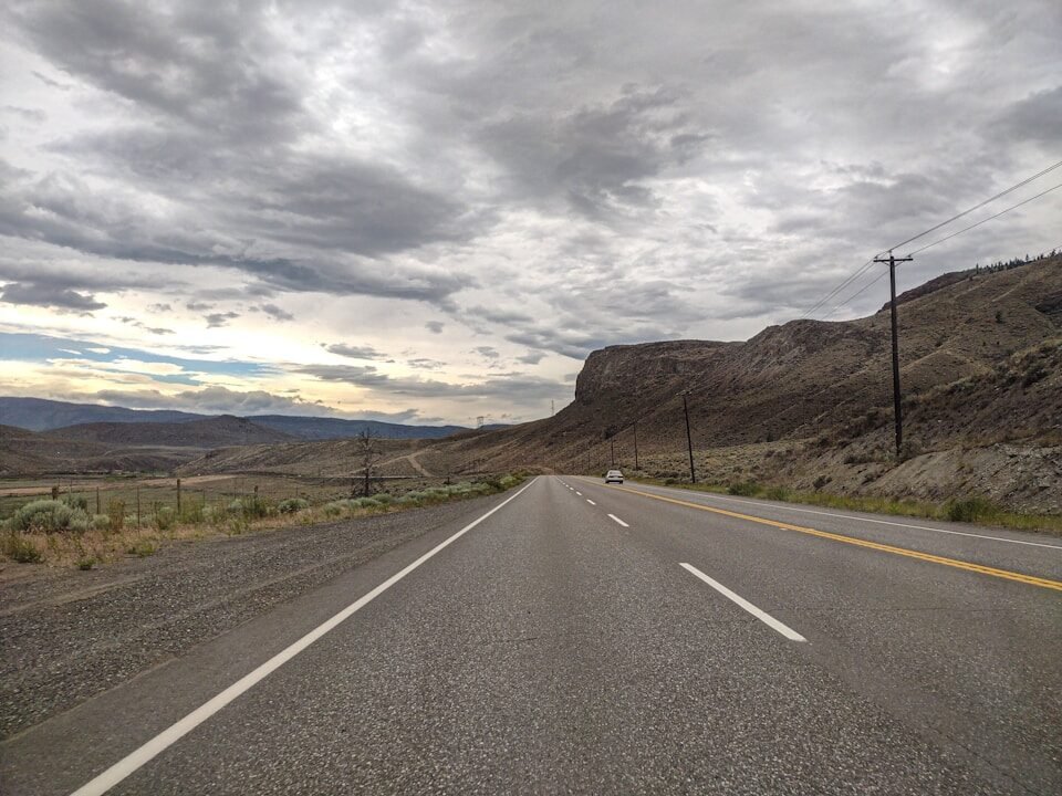 An empty road with a mountain in the background