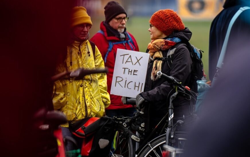 A person in a wheelchair holding a sign