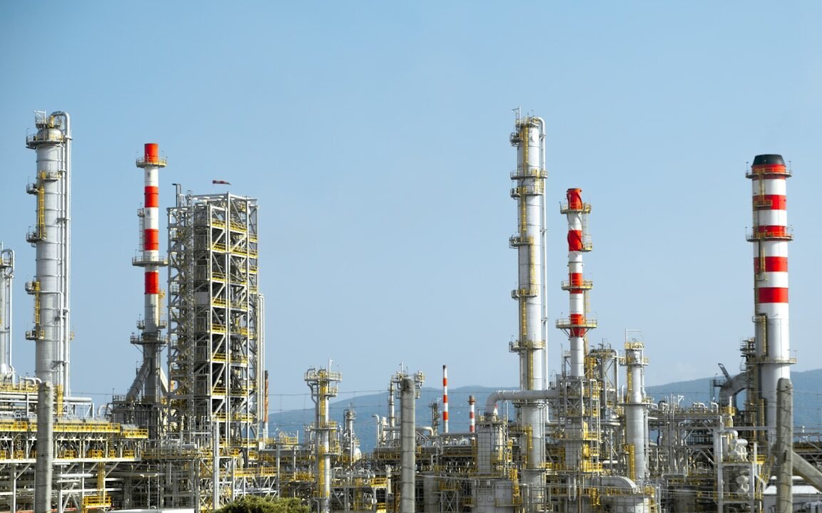A factory with a lot of red and white pipes
