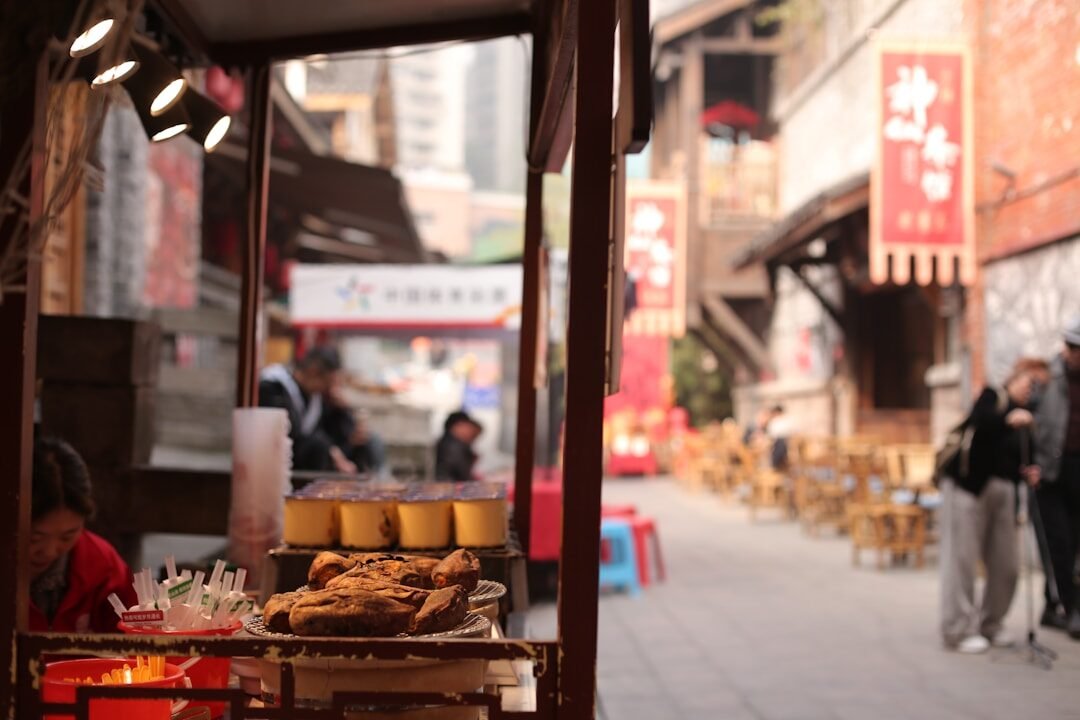 Street food stall with customers in a bustling alley