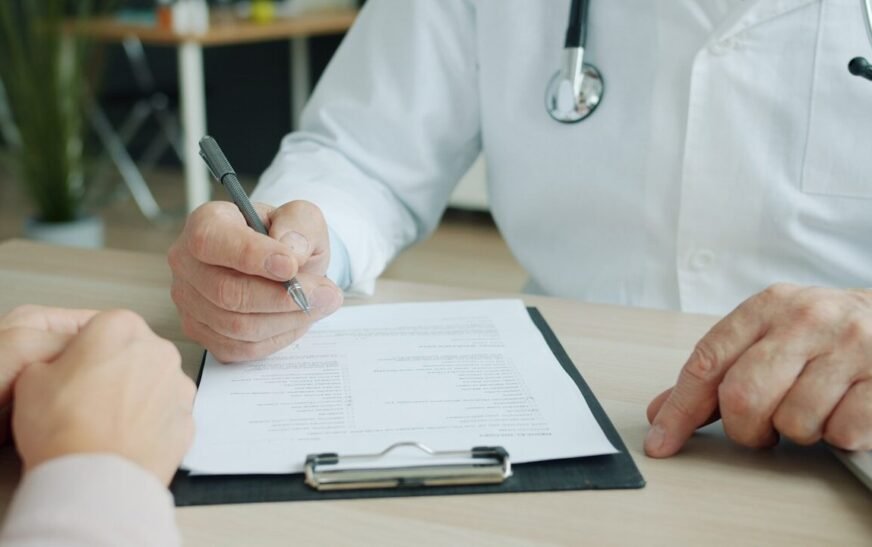 Doctor writing on a patient's chart