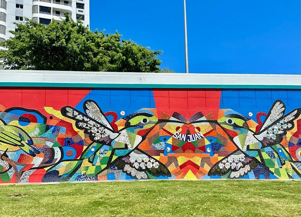 Colorful mural with two hummingbirds and abstract shapes.