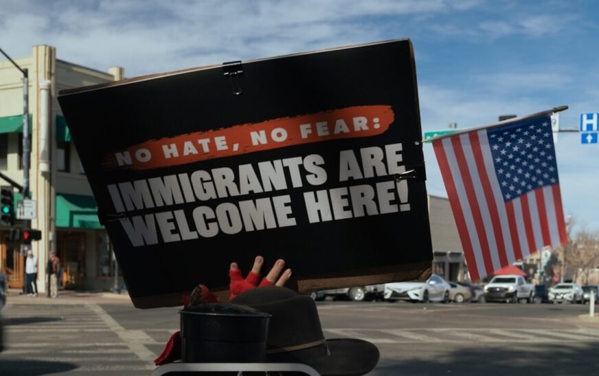 Protest sign reads immigrants are welcome here