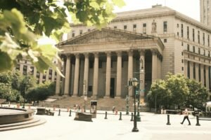 A neoclassical courthouse is shown on a sunny day.
