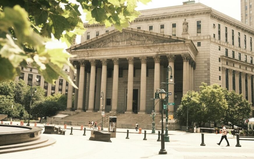 A neoclassical courthouse is shown on a sunny day.
