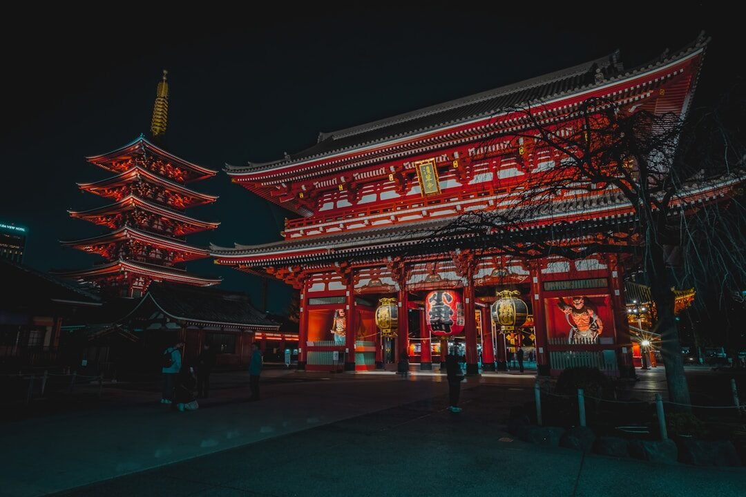 a tall building with red lights in front of it
