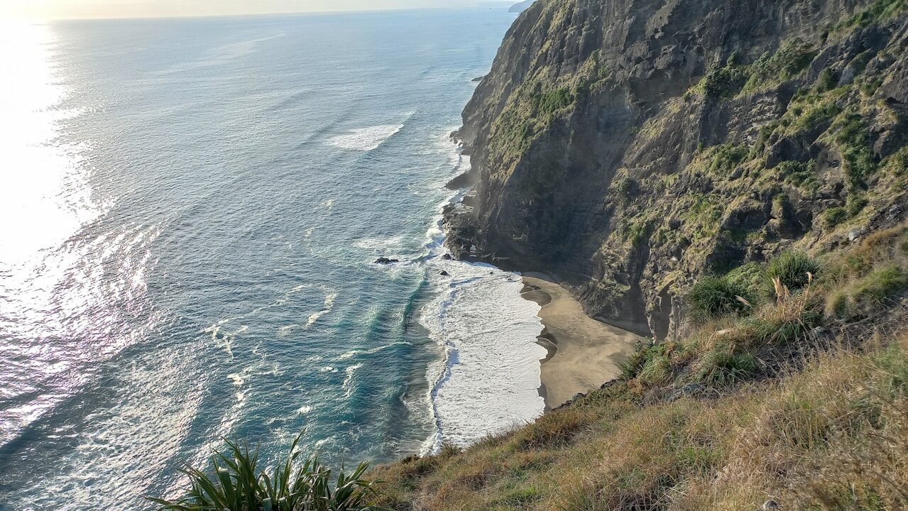 a beach with a body of water by it