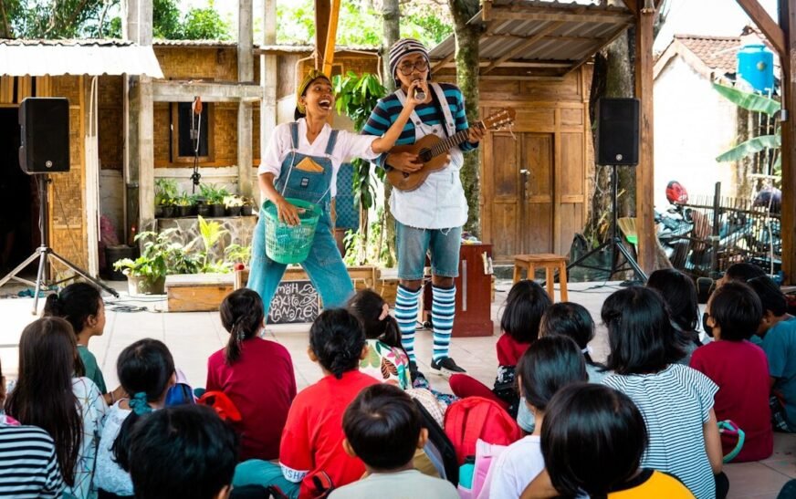 Performers entertain children with music and laughter.
