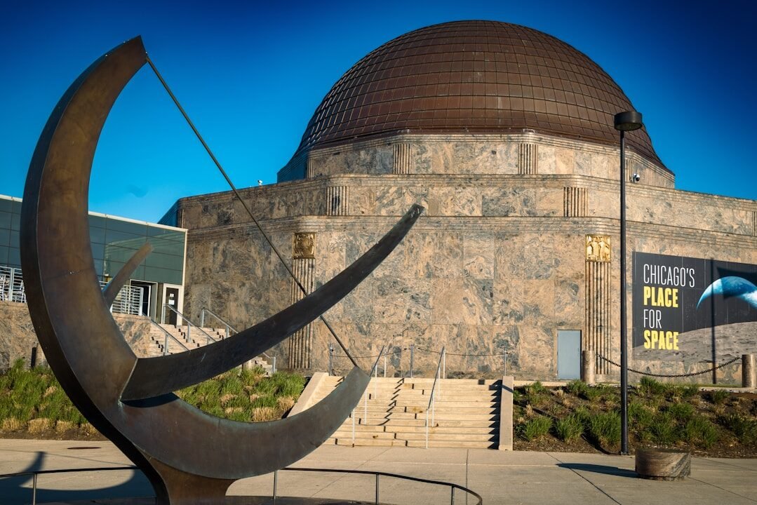Abstract sculpture before chicago's domed place for space.