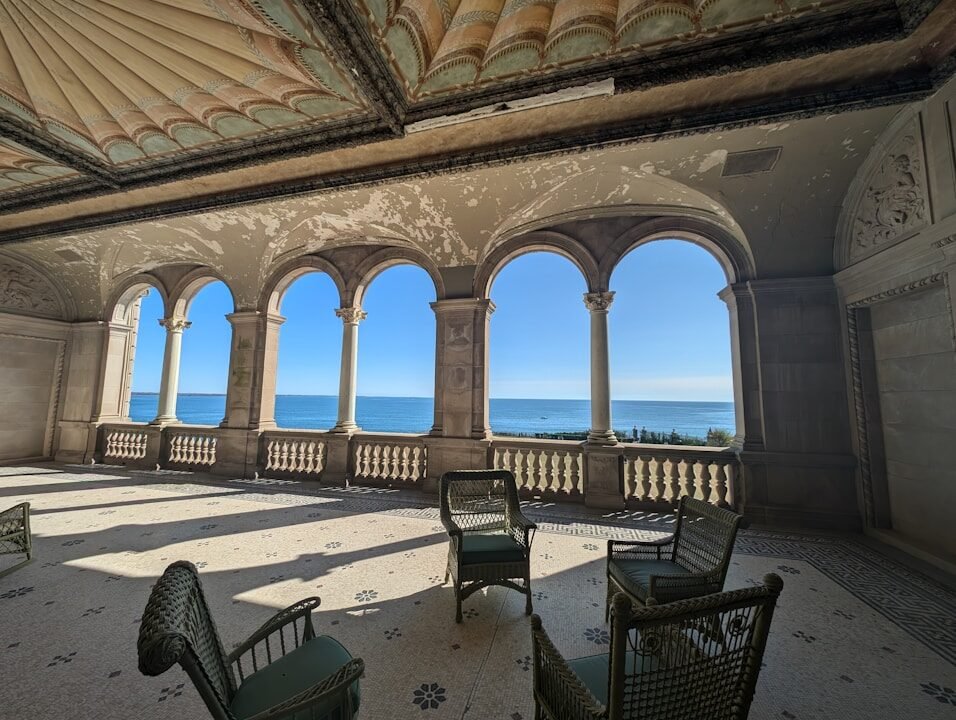 A large room with chairs and a view of the ocean