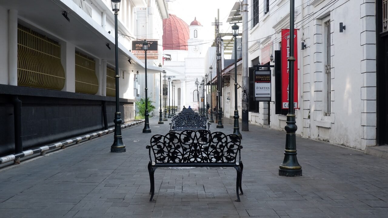 a bench sitting in the middle of a street
