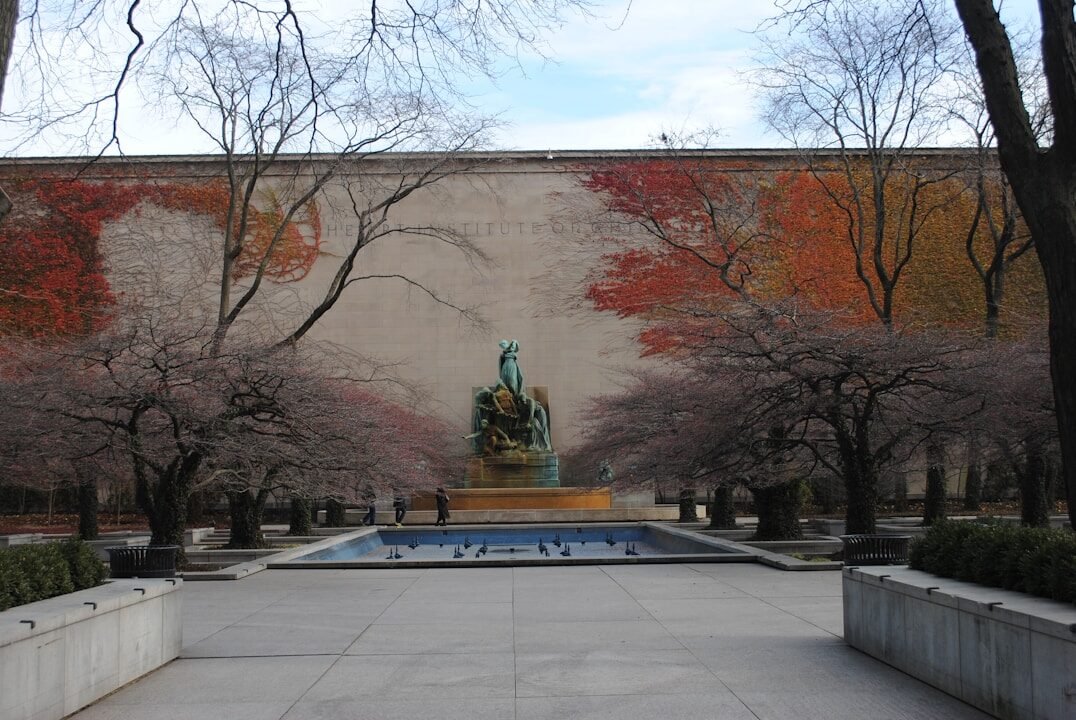 statue of man on gray concrete bench