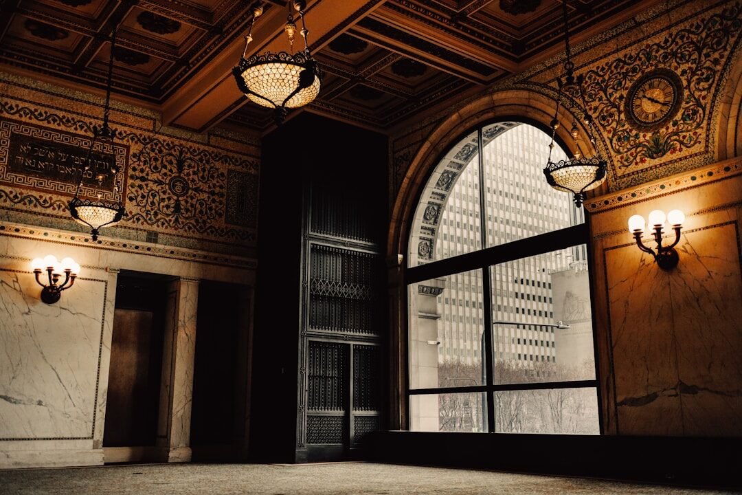 Elegant interior with ornate ceiling and large window.