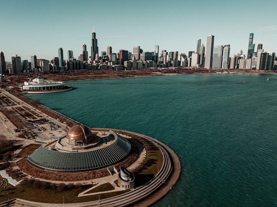 a large body of water with a city in the background