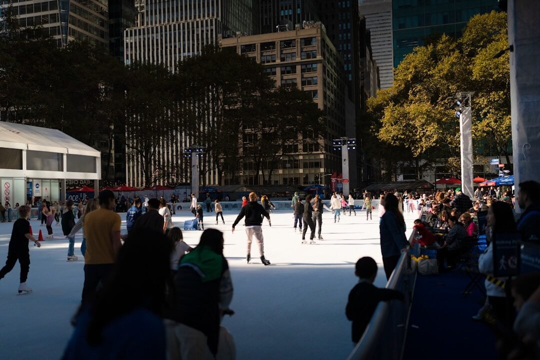 A group of people skating on an ice rink