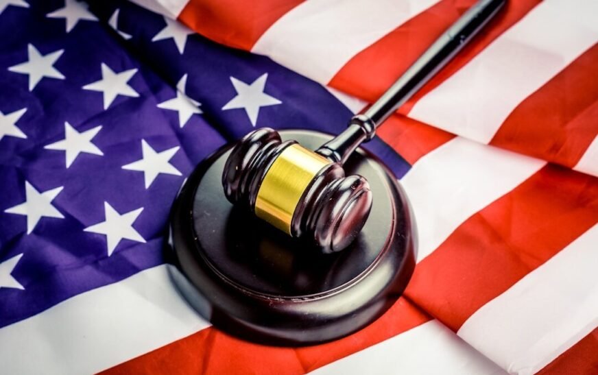 a judge's gavel on top of a flag