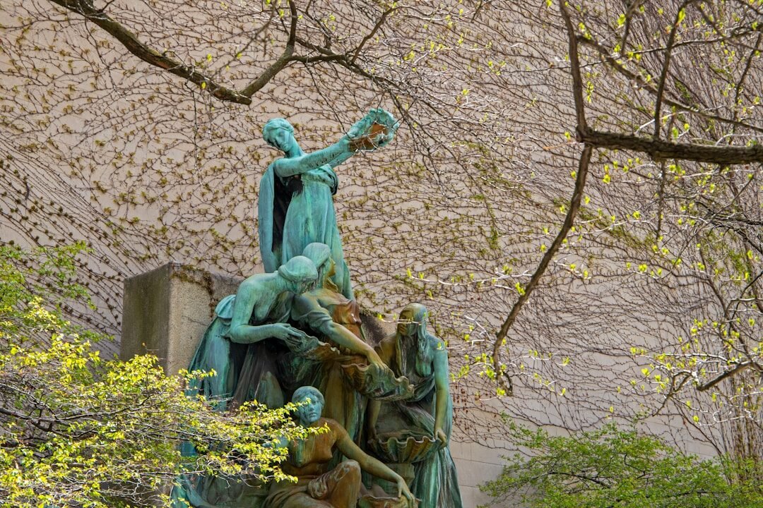 a statue of a group of people holding a cross