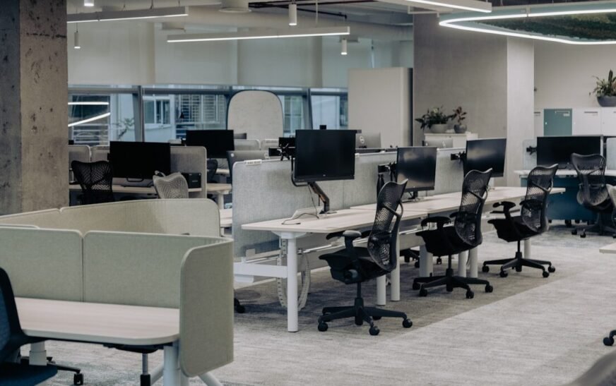 an office with a lot of desks and chairs