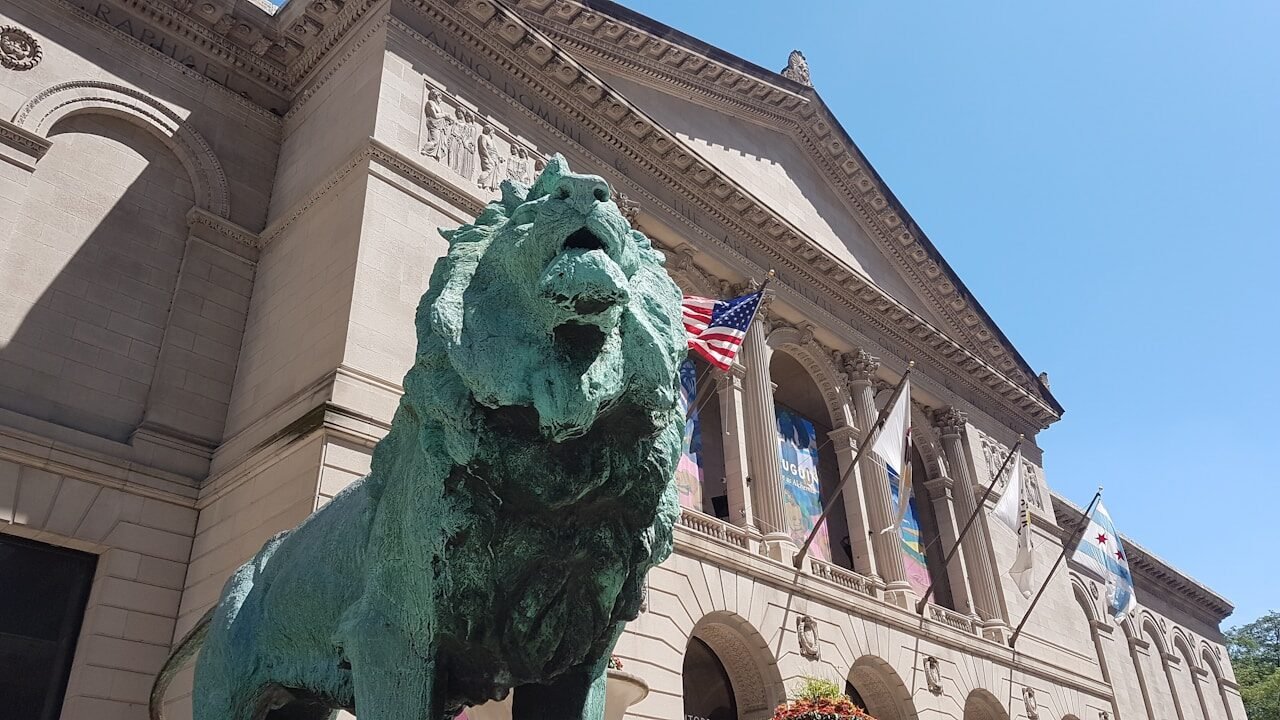 a statue of a lion in front of a building
