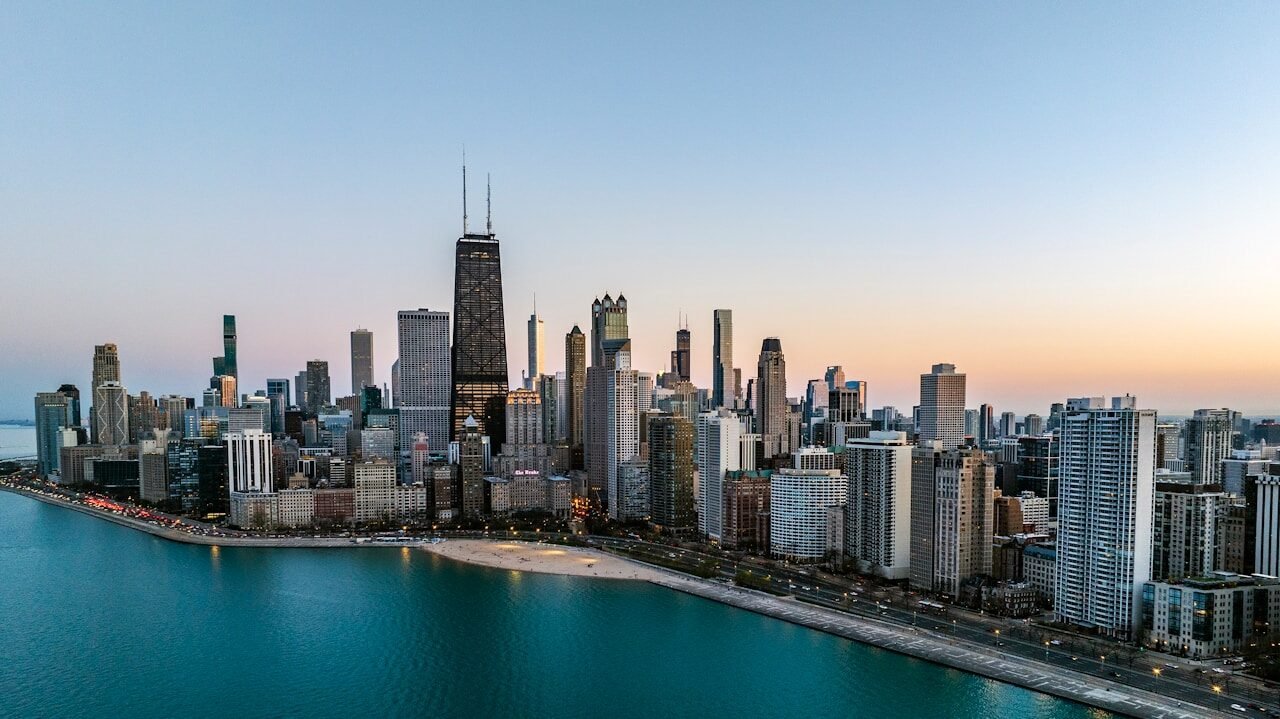 an aerial view of a large city next to a body of water