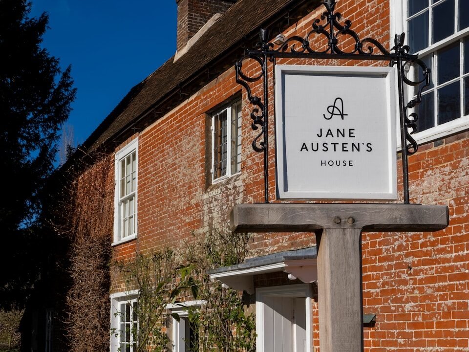 Jane austen's house sign on brick building