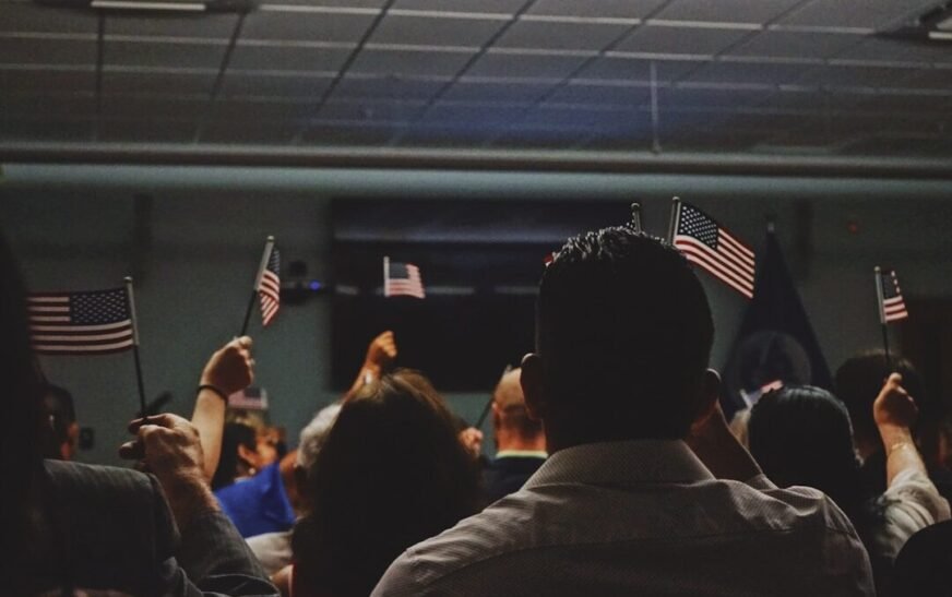 people holding flag of U.S.A miniature