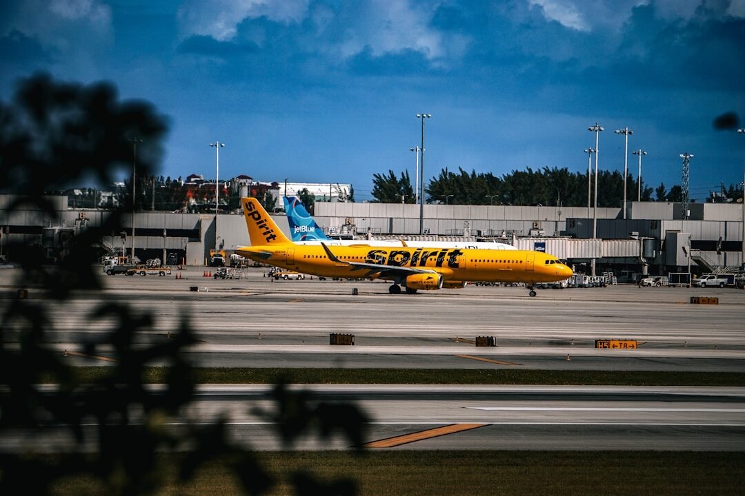 A yellow and blue plane is on the runway