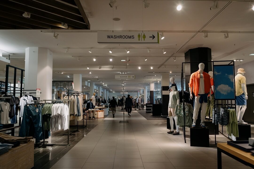 Inside of a department store with clothes on display.