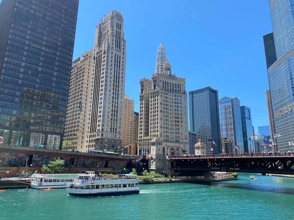 white and black boat on water near city buildings during daytime