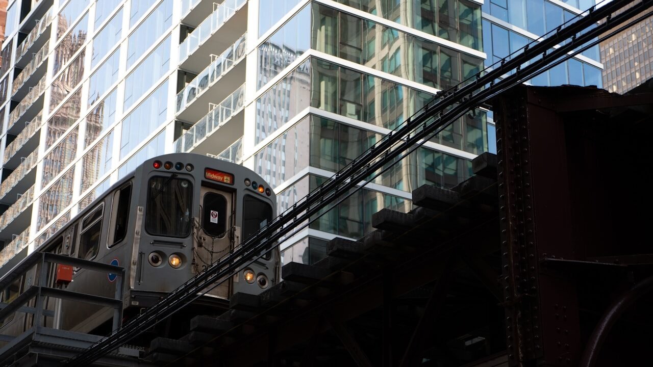 yellow and black train in the city during daytime