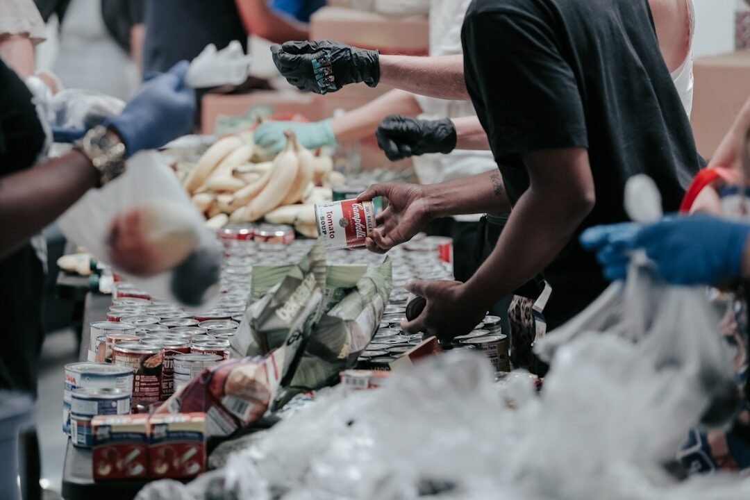 volunteers sorting canned food donations