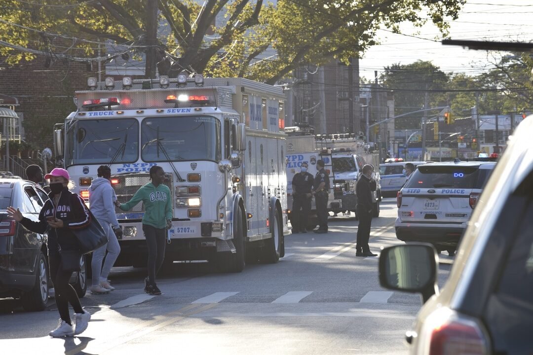 Emergency scene with fire truck and pedestrians on a street
