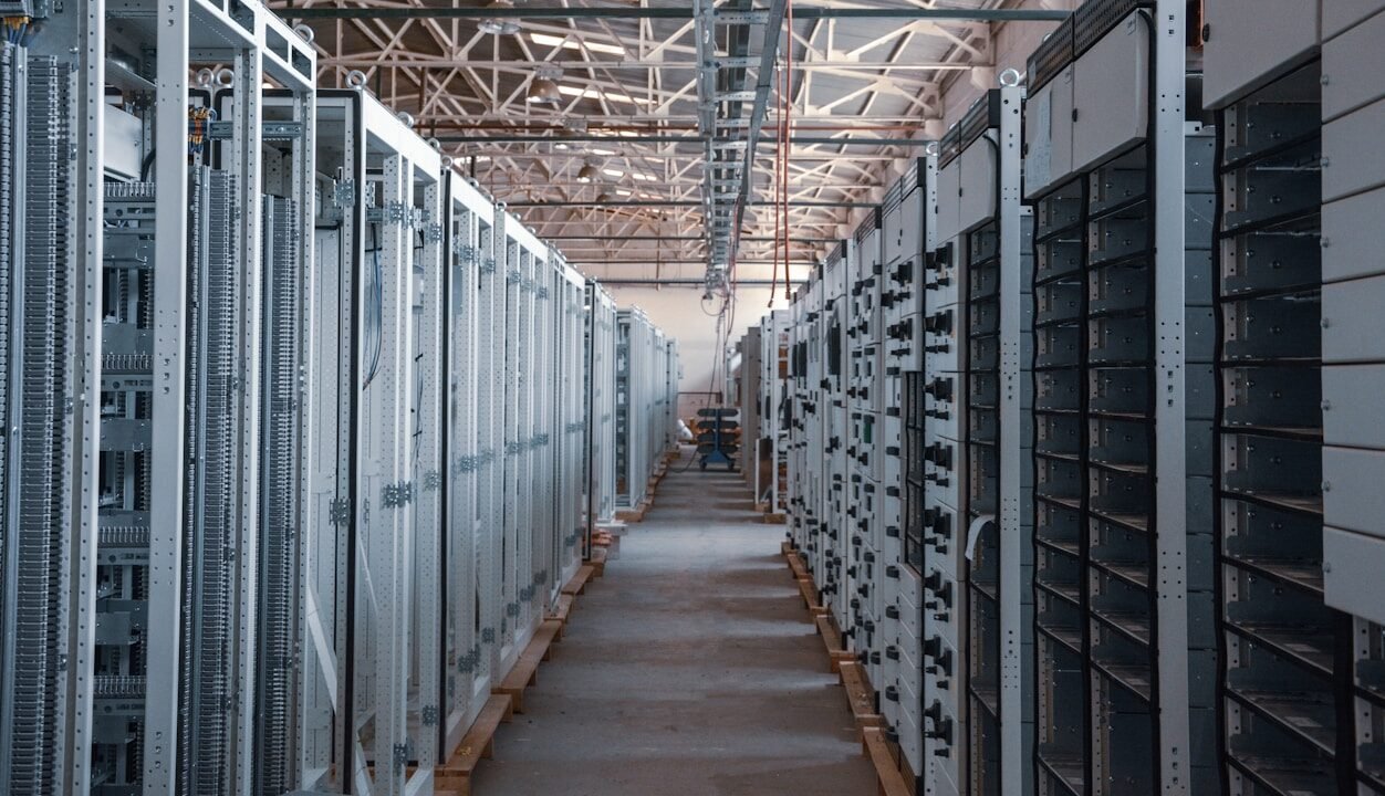 server room aisle with metal equipment racks