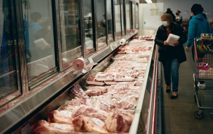 a line of meat in a grocery store